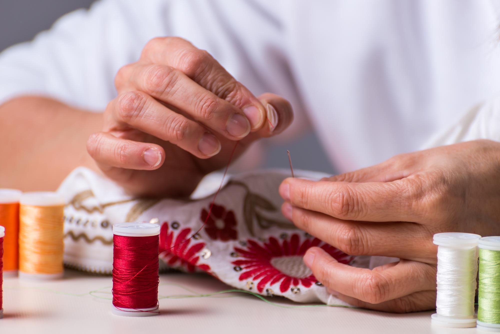 senior embroiderer hands at work